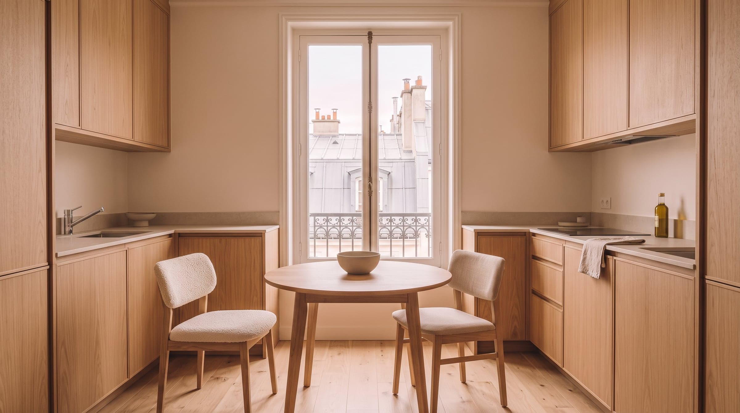 L-shaped small kitchen with a dining corner and a small table set under a tall window